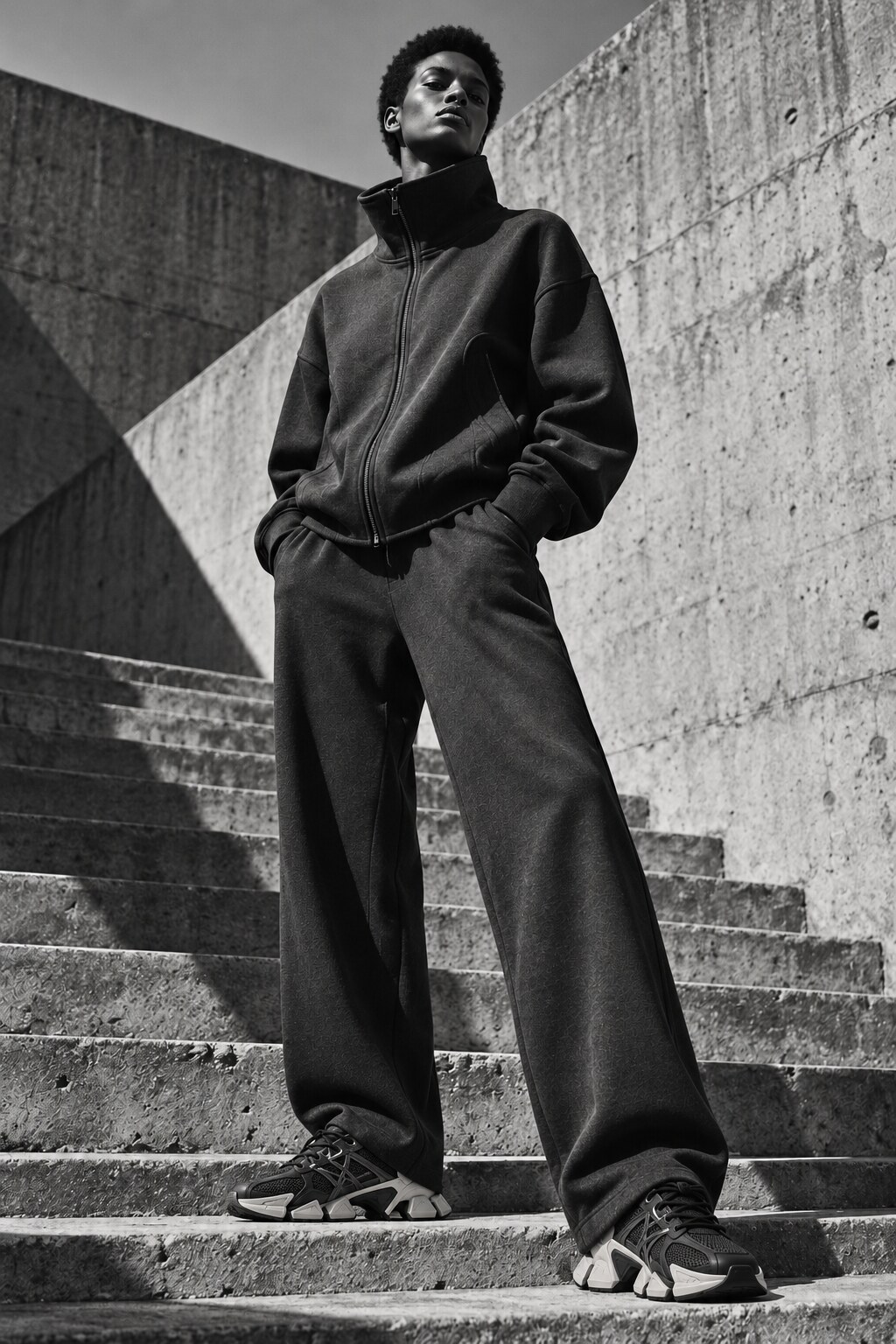 Woman wearing a sculptural tracksuit with Japanese-design-inspired technical trainers